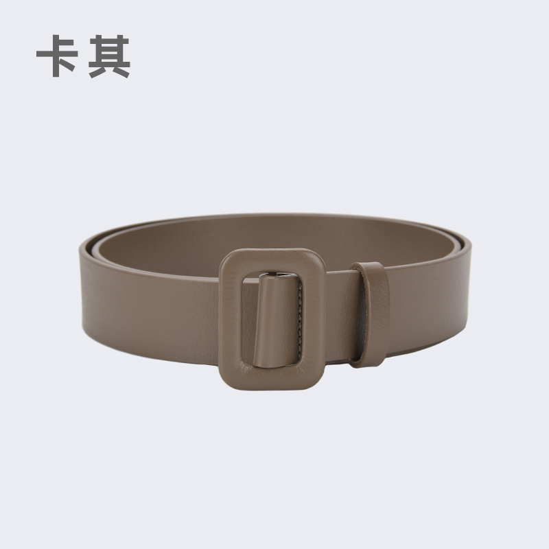 A classic and versatile wide belt with a cinched waist and decorative strap for women, paired with a dress