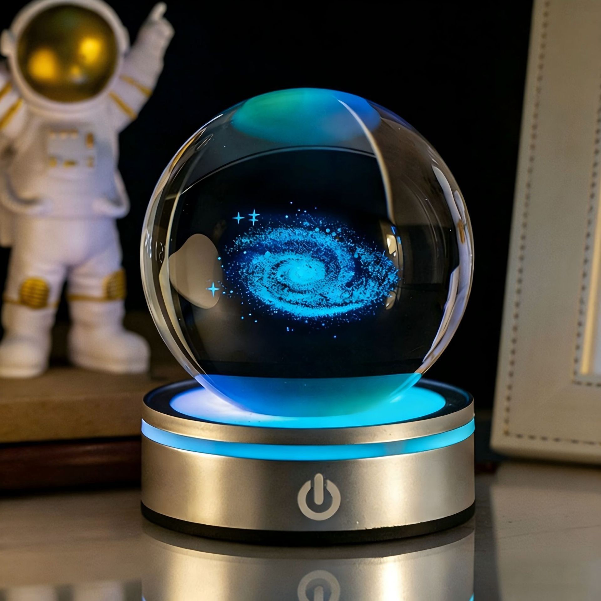 A creative night light table decoration with a luminous crystal ball engraved with starry skies and the Milky Way. A birthday gift for a girl