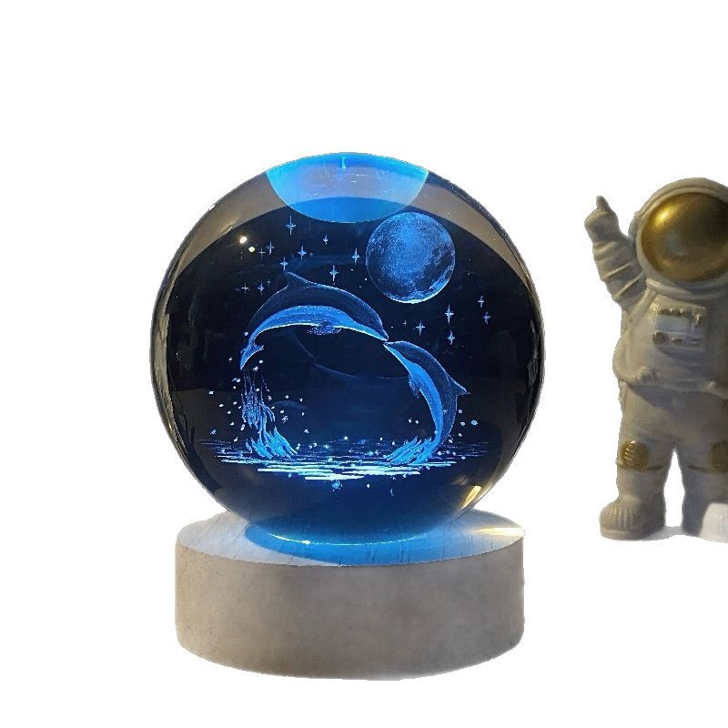 A creative inner-carved crystal ball night light ornament with a seven-color illuminated solid wood base. A crystal ball ornament gift for friends