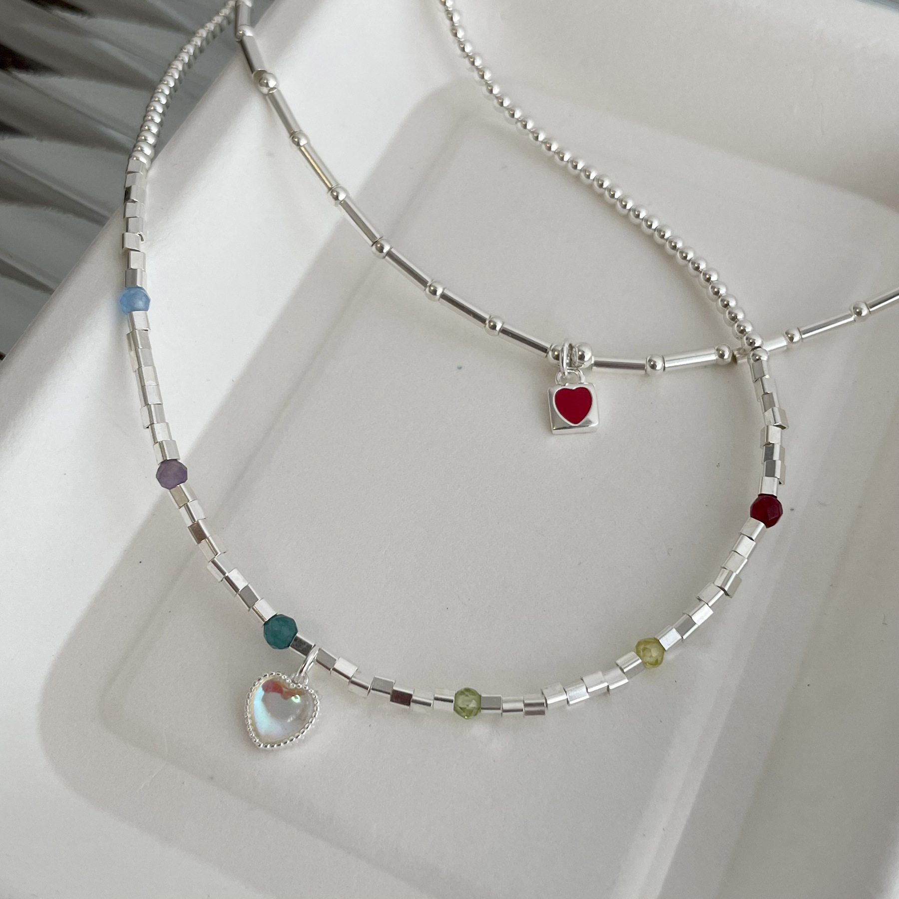 Ins-style, luxurious handmade beaded clavicle necklace with a red heart-shaped pendant, featuring a bamboo design and moonstone heart. It exudes a sweet and elegant charm.