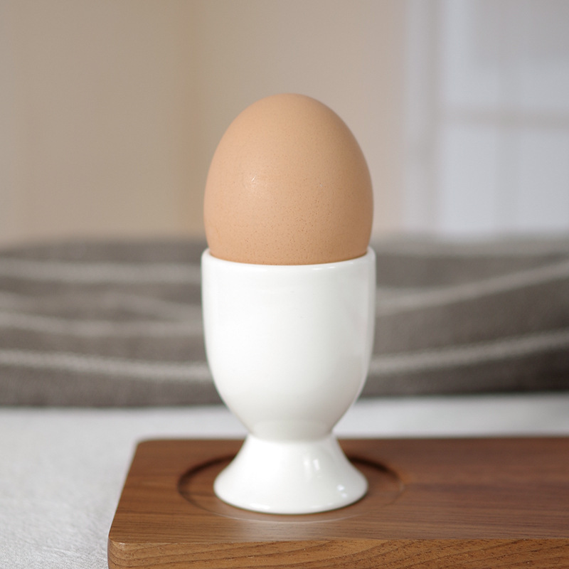Pure white bone china egg tray cups, creatively designed for hotels, clubs, restaurants, and home use. Direct factory source, logo printing supported.