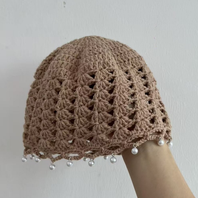 Women's crocheted openwork cap with tassels and pearl pendants, perfect for vacation.
