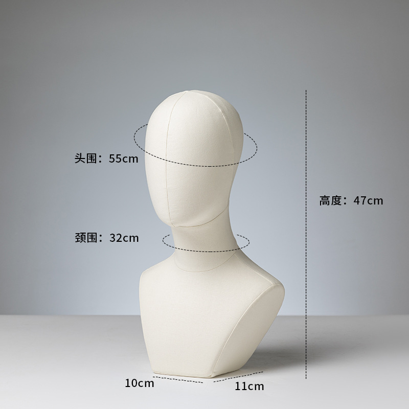 Colorful head mannequins, wigs, hats, necklaces, scarves, display racks, weather vanes, foam mannequin heads, props with pins inserted.