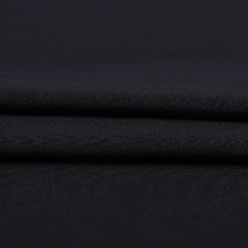 Wide-width plain weave peach skin polyester fabric for clothing, beach shorts, bags, and shopping bags.