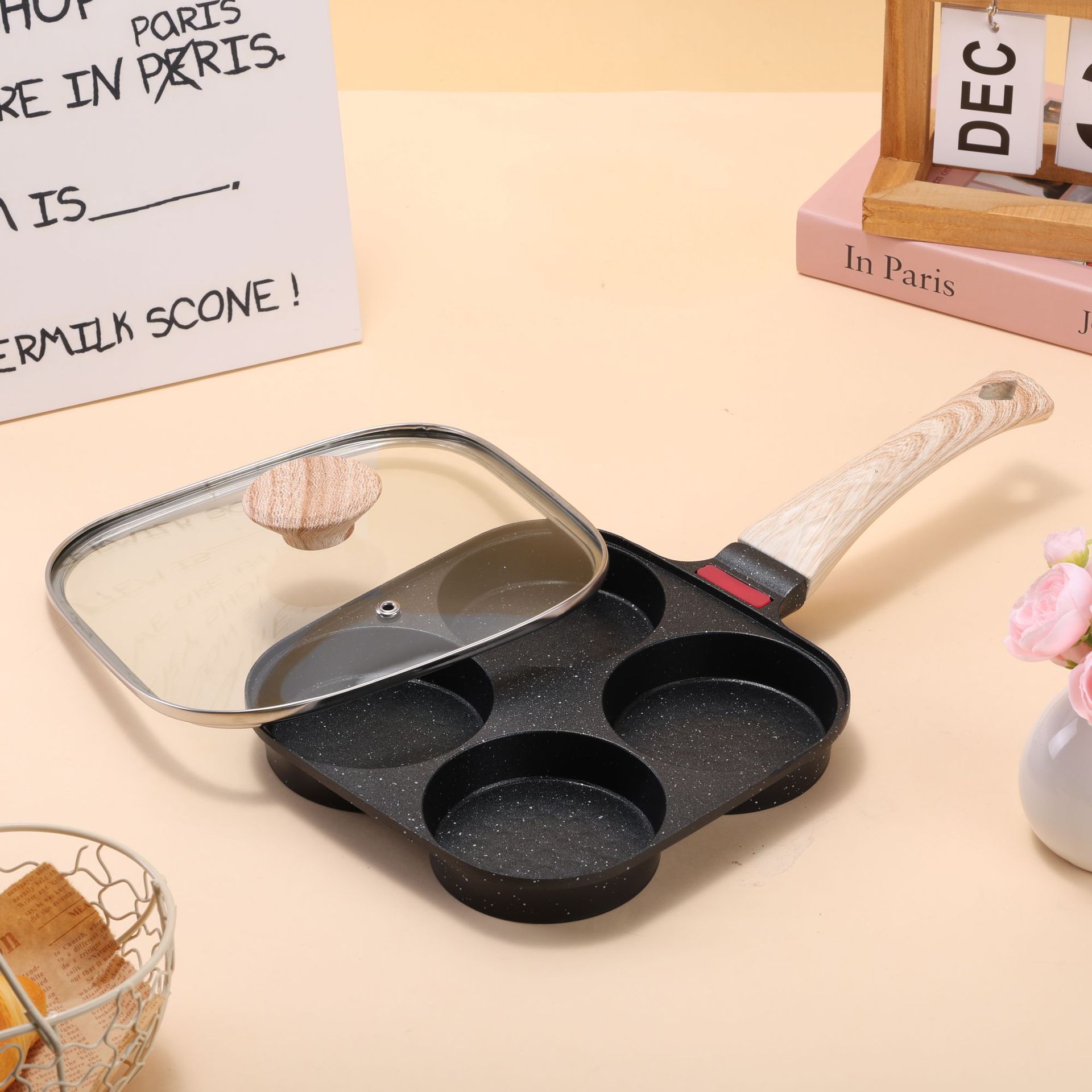 A four-hole breakfast frying pan with a lid, featuring a non-stick coating of tourmaline and a deepened design. It is a universal pan for eggs, hamburgers and fried eggs