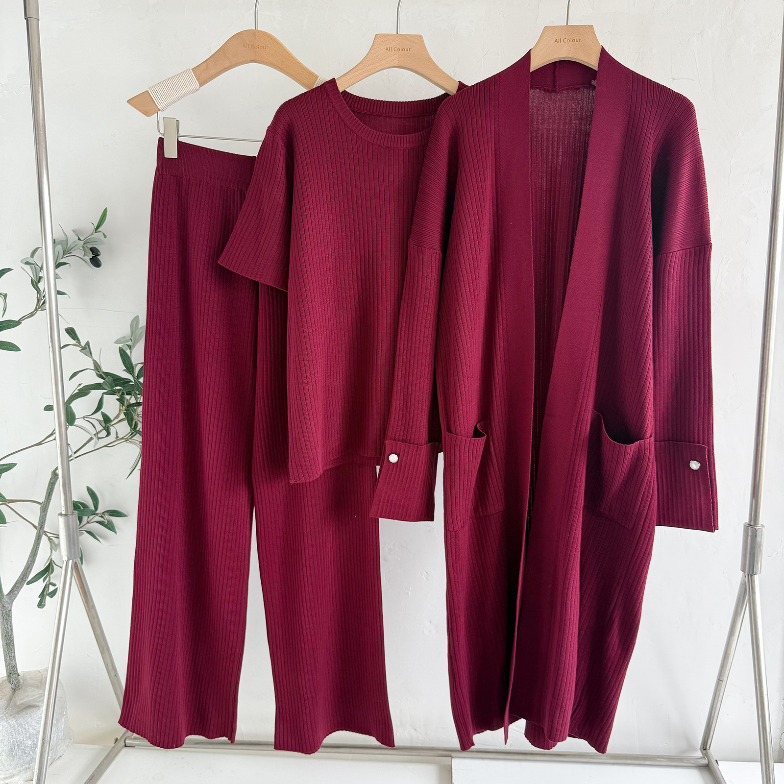 A trendy three-piece cross-border trade knitted set for women's autumn and winter, featuring a mid-length cardigan jacket, a short-sleeved top and wide-leg pants