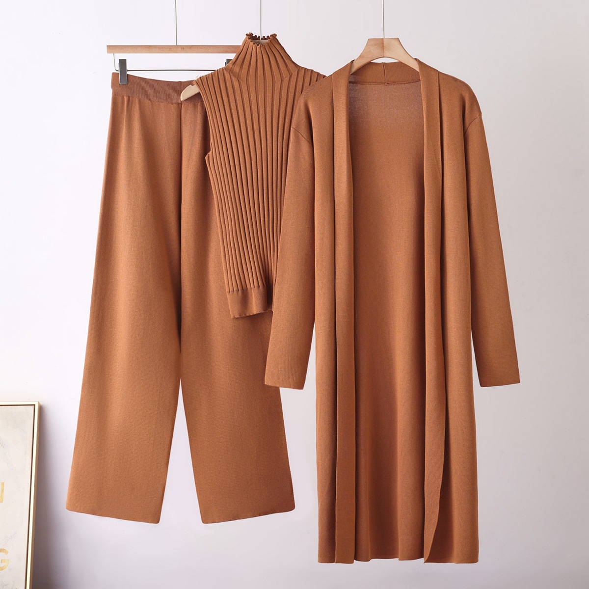 A stylish solid-color casual set for women, featuring a shawl coat, a V-neck base knitted sweater and wide-leg trousers